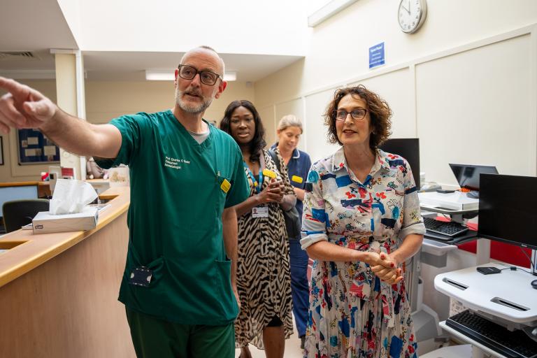 Baroness Merron and Prof Charles Roehr walk through NICU Gifty markey follows behind