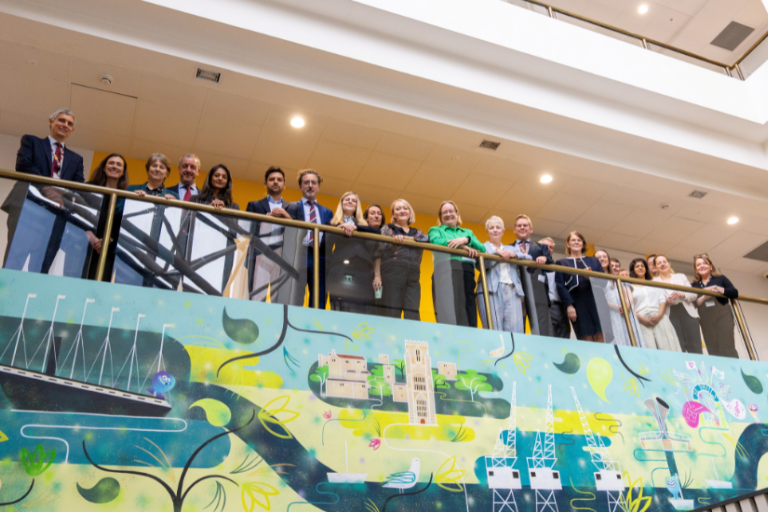 Colleagues posing for group photo in the Central Health Clinic in Bristol