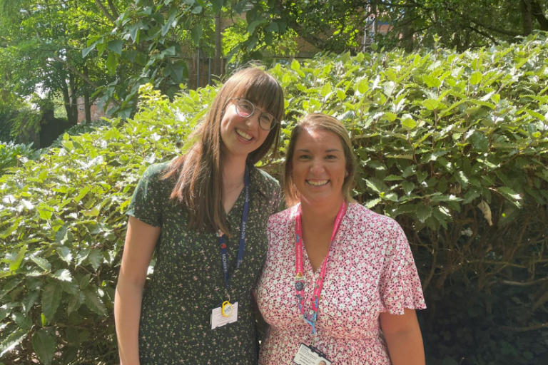 The Snowdrop team smile for picture surrounded by greenery