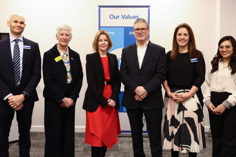 Prime Minister Keir Starmer smiles in group photo with Maria Kane, Ingrid Barker and InHealth team