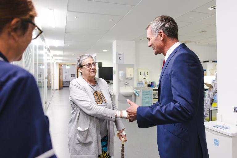 Rt Hon Peter Kyle MP shaking hands with patient in a clinical setting