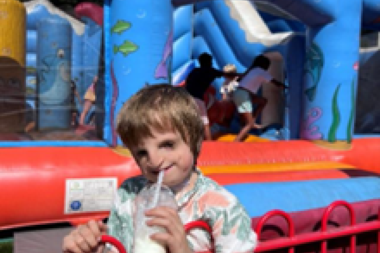William enjoying a celebratory milkshake at park after his tracheostomy tube was removed