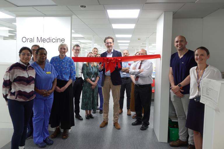 Matthew Jerreat cutting the ribbon for the Oral Medicine Department with Dental Hospital staff