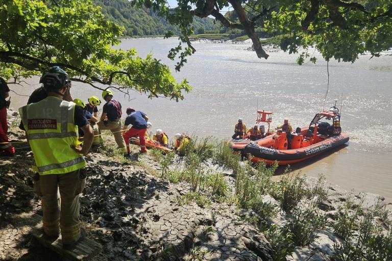 Lewis being rescued by boat down the River Wye