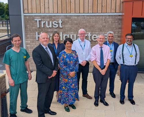 Group photo of Professor Meghana Pandit and Dr Trevor Smith with North Bristol Trust colleagues outside trust headquarters