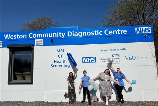 Staff pose outside Weston Community Diagnostic Centre with balloons