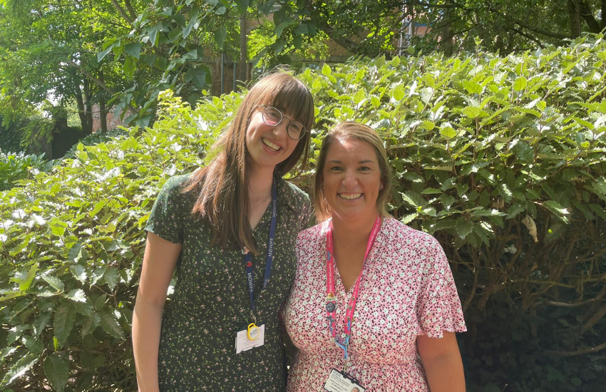 The Snowdrop team smile for picture surrounded by greenery