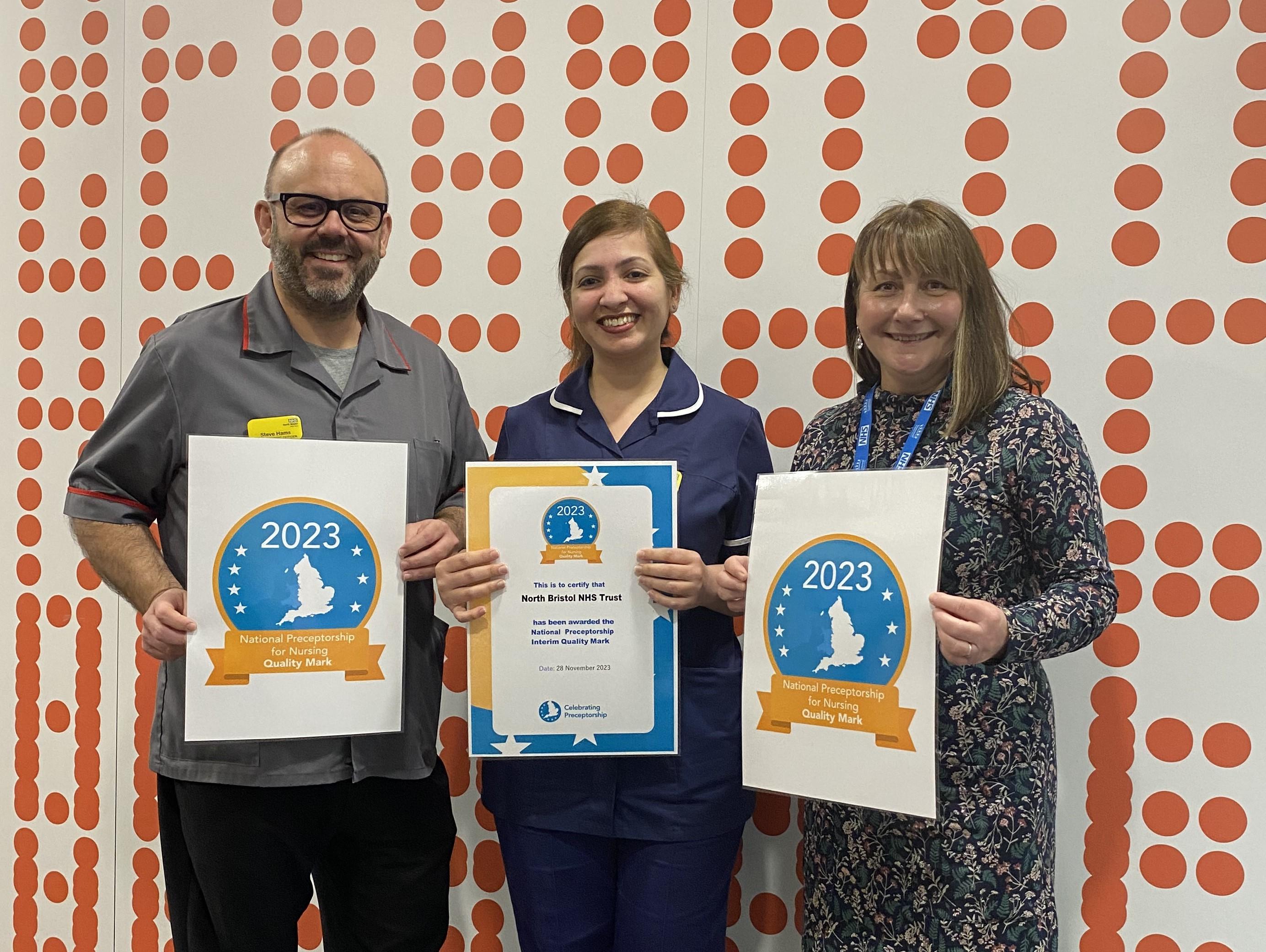 Steve Hams with two preceptorship team members holding up their certificates