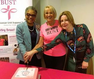 Mrs Peaches Golding OBE, Jenny Wookey, and Maria Kane pose cutting the BUST thank you cake