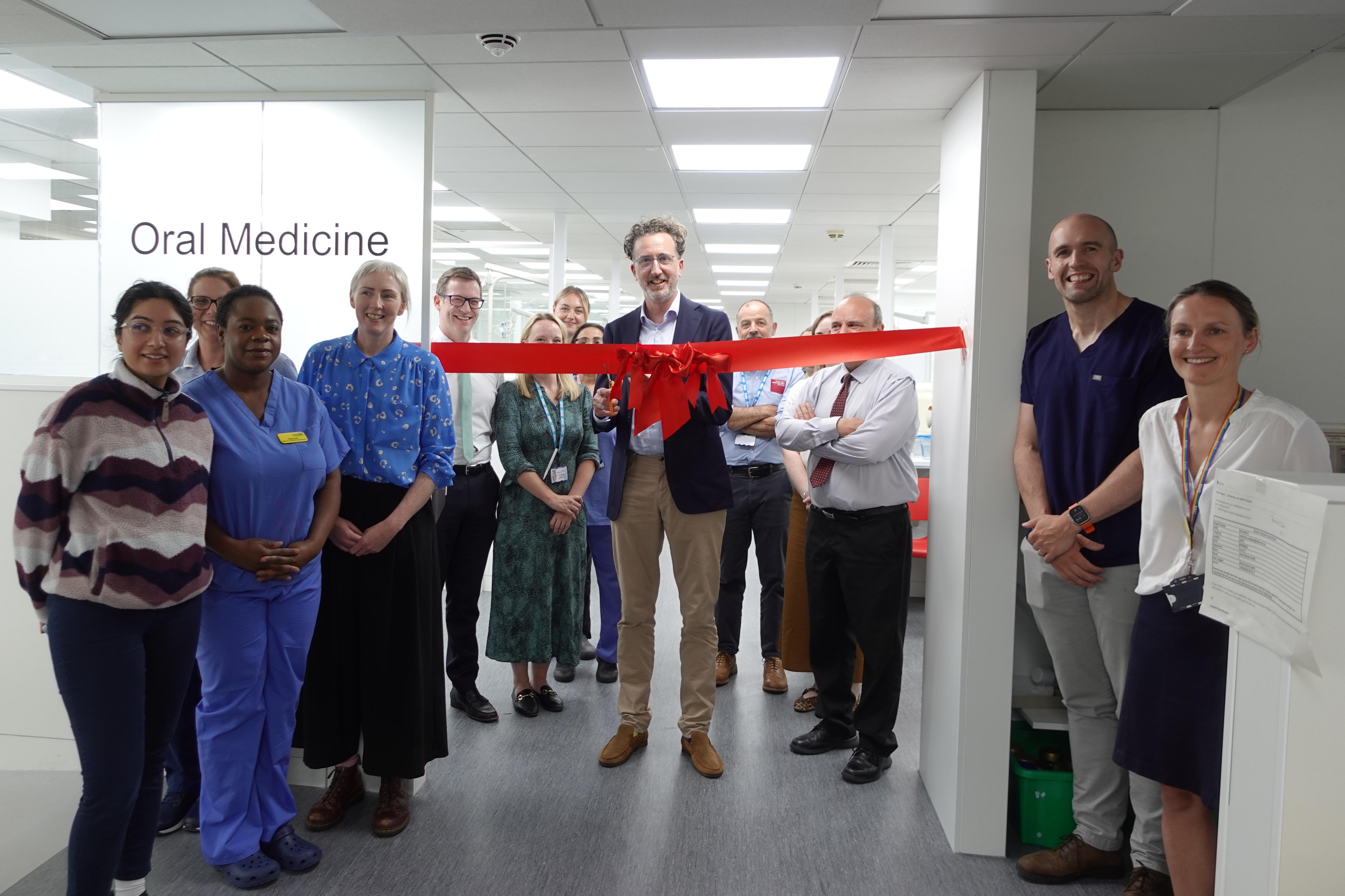 Matthew Jerreat cutting the ribbon for the Oral Medicine Department with Dental Hospital staff