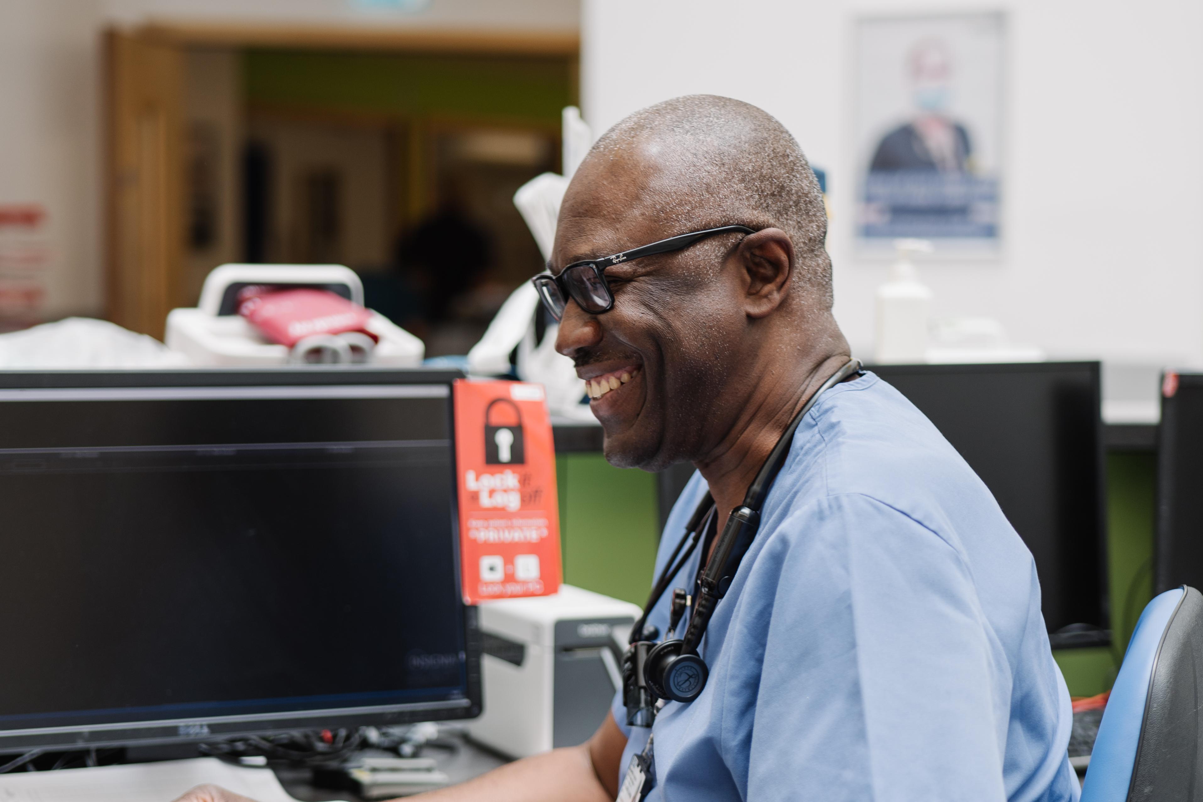 A clinical staff member sat at a desk
